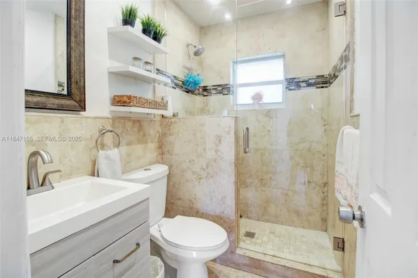 a bathroom with a sink toilet and shower