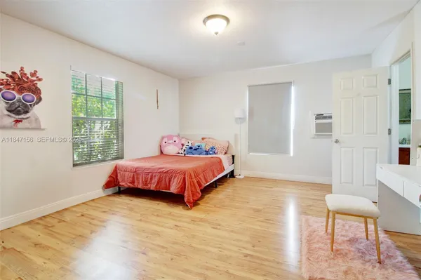 a bedroom with a bed and a chair