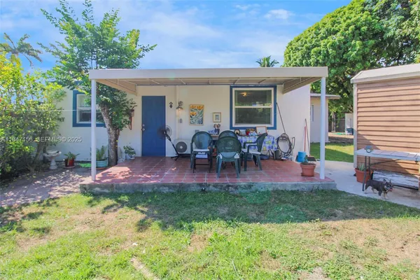 a view of a house with backyard porch and sitting area