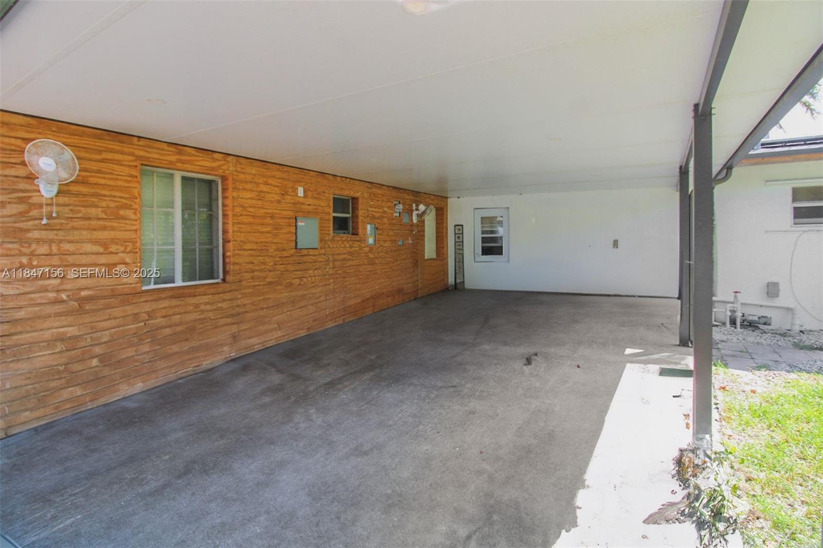 9755 Southwest 161st Street Miami, FL 33157 - Photo 25 of 32 a view of an empty room with a window