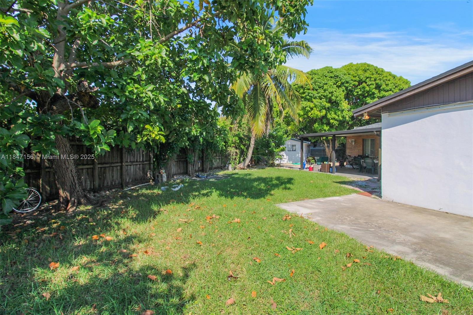 9755 Southwest 161st Street Miami, FL 33157 - Photo 26 of 32 a view of backyard with table and chairs and wooden fence