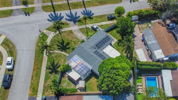 an aerial view of a house with a yard and garden