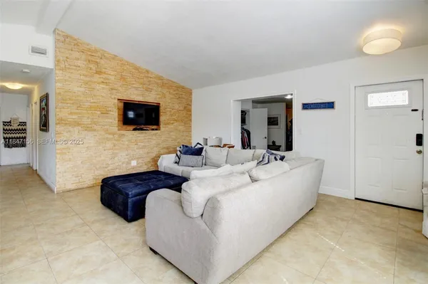 a living room with couches and a flat screen tv