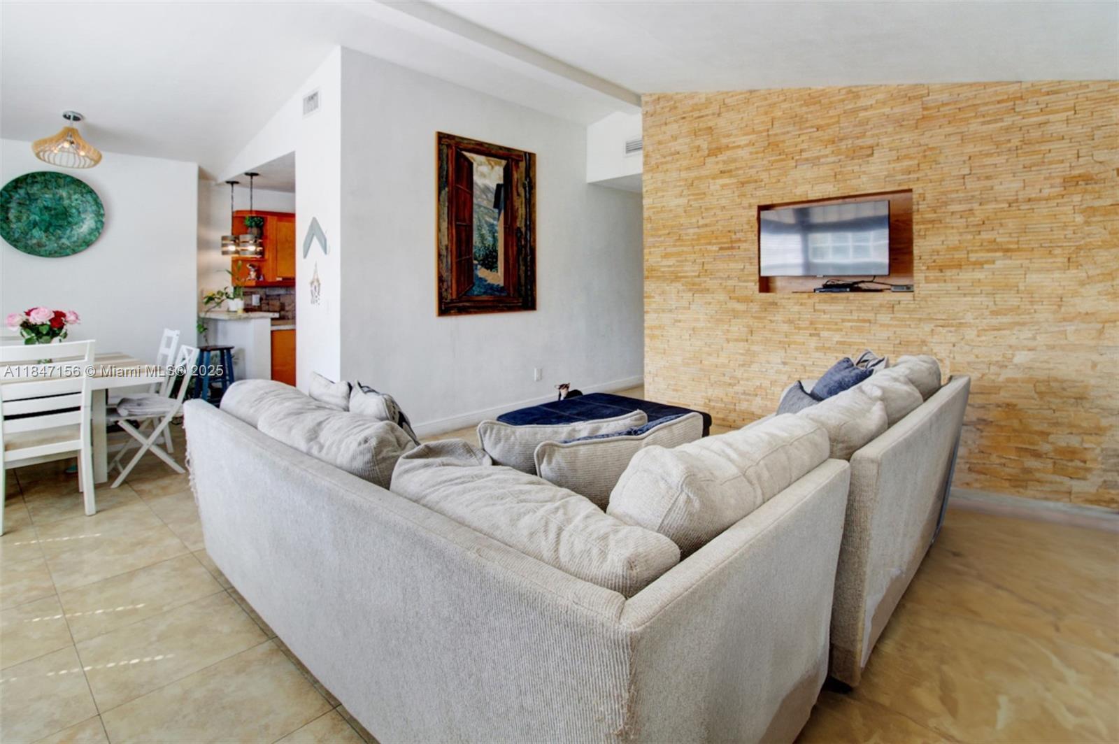 9755 Southwest 161st Street Miami, FL 33157 - Photo 7 of 32 a living room with furniture and a flat screen tv