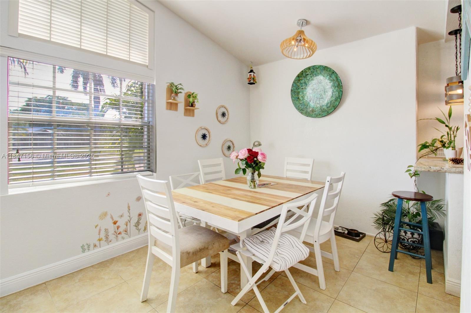 9755 Southwest 161st Street Miami, FL 33157 - Photo 9 of 32 a view of a dining room with furniture and a large window