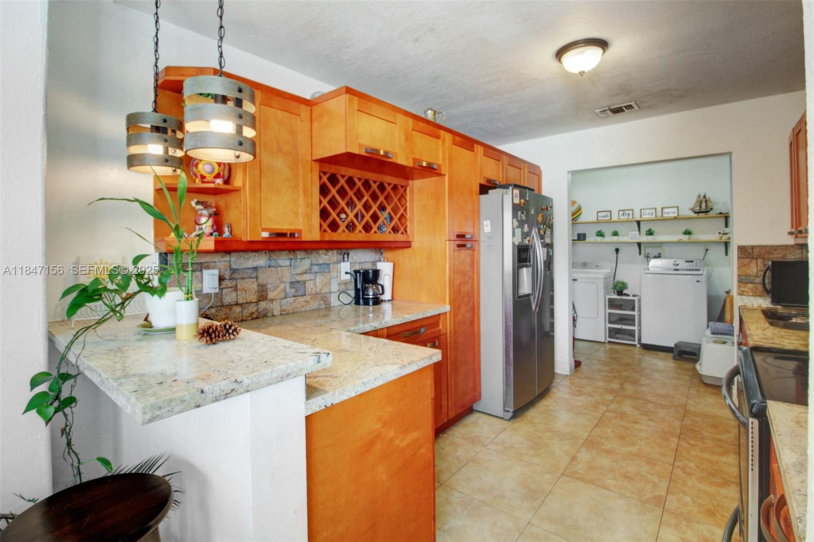 9755 Southwest 161st Street Miami, FL 33157 - Photo 10 of 32 a kitchen with refrigerator and stove