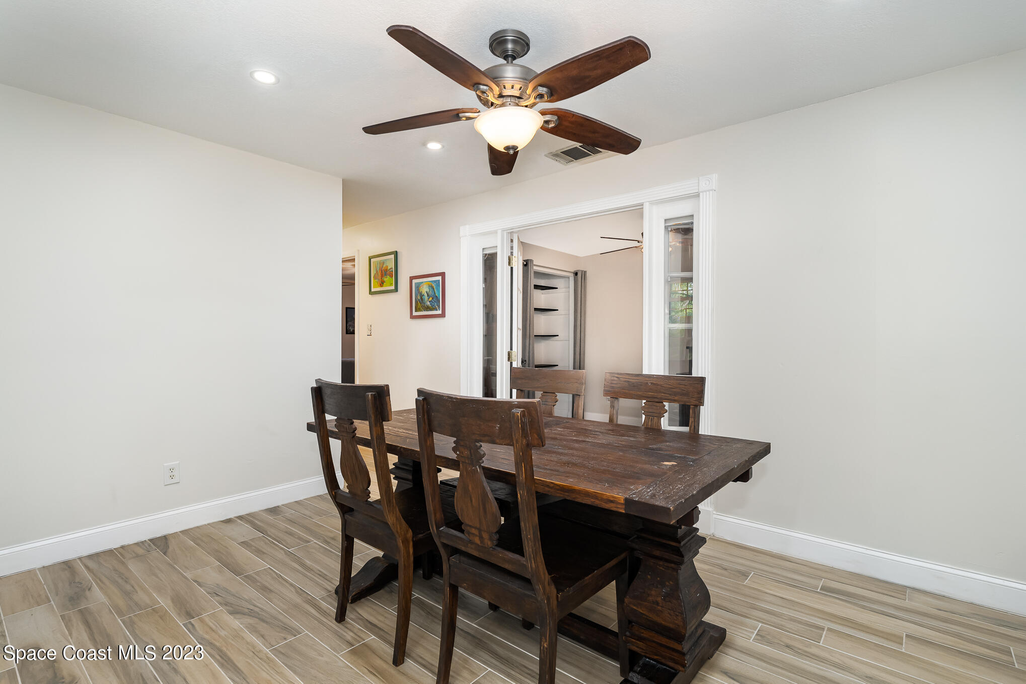2842 Watkins Drive Melbourne, FL 32901 - Photo 11 of 39 a view of a dining room with furniture and a chandelier fan