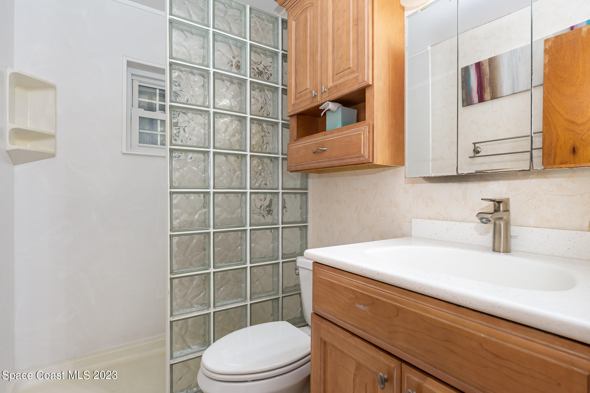 2842 Watkins Drive Melbourne, FL 32901 - Photo 12 of 39 a bathroom with a sink a toilet and a mirror