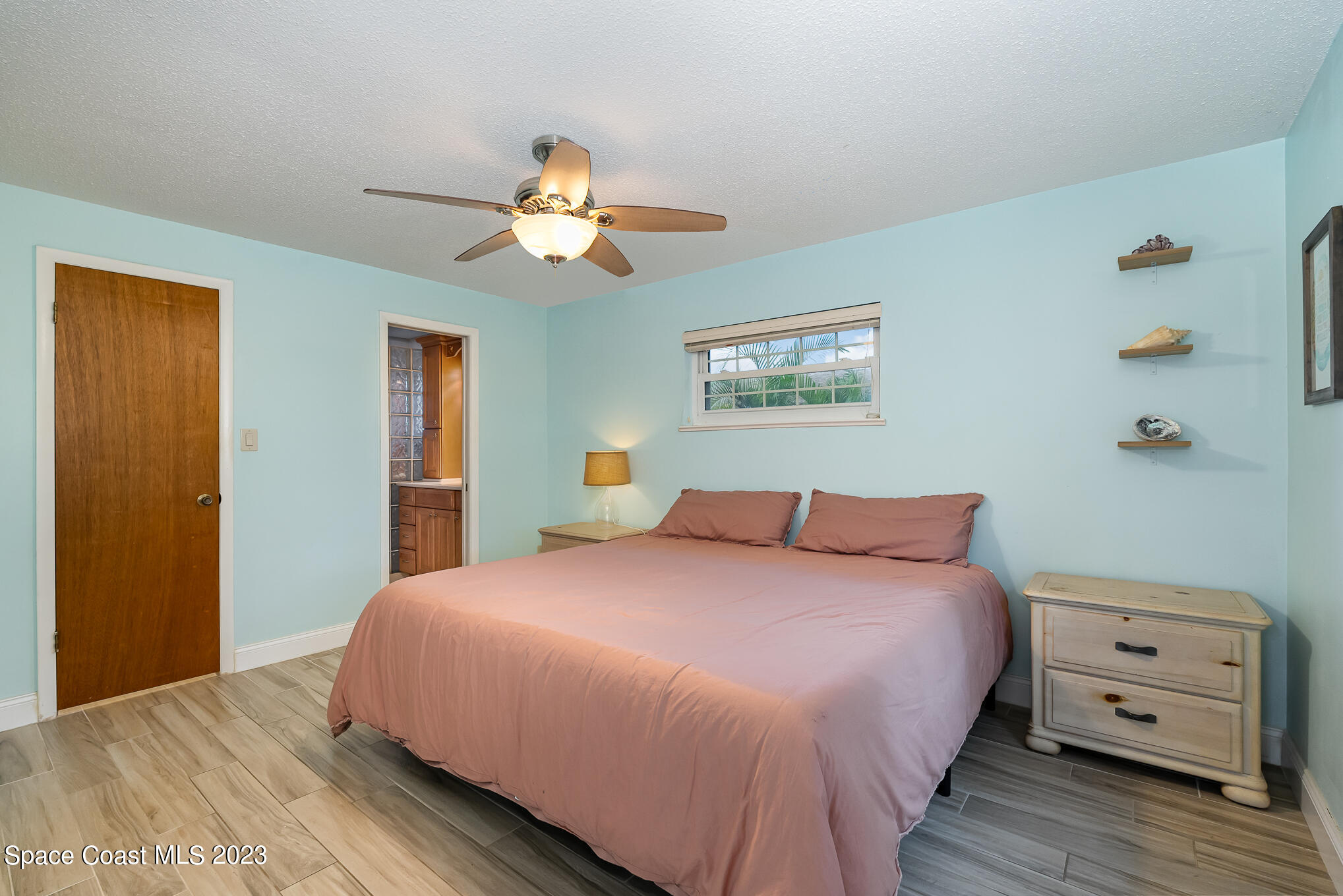 2842 Watkins Drive Melbourne, FL 32901 - Photo 13 of 39 a bedroom with a bed and a dresser