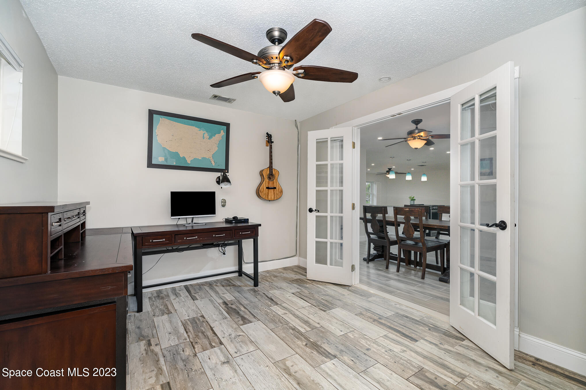 2842 Watkins Drive Melbourne, FL 32901 - Photo 19 of 39 a work room with wooden floor and furniture