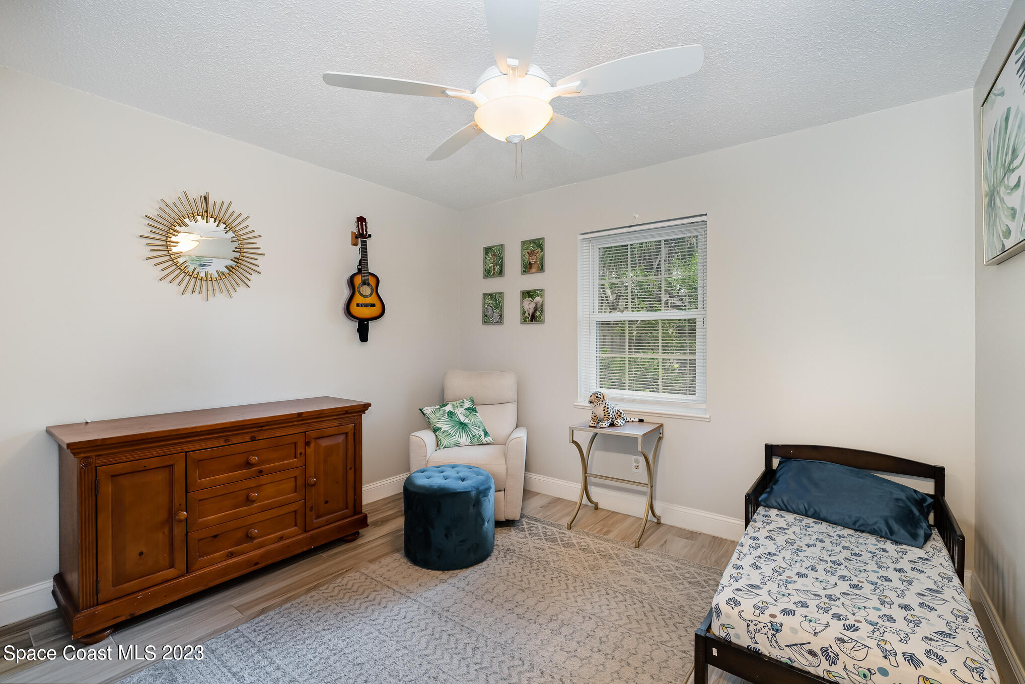 2842 Watkins Drive Melbourne, FL 32901 - Photo 20 of 39 a bedroom with a bed and a chandelier