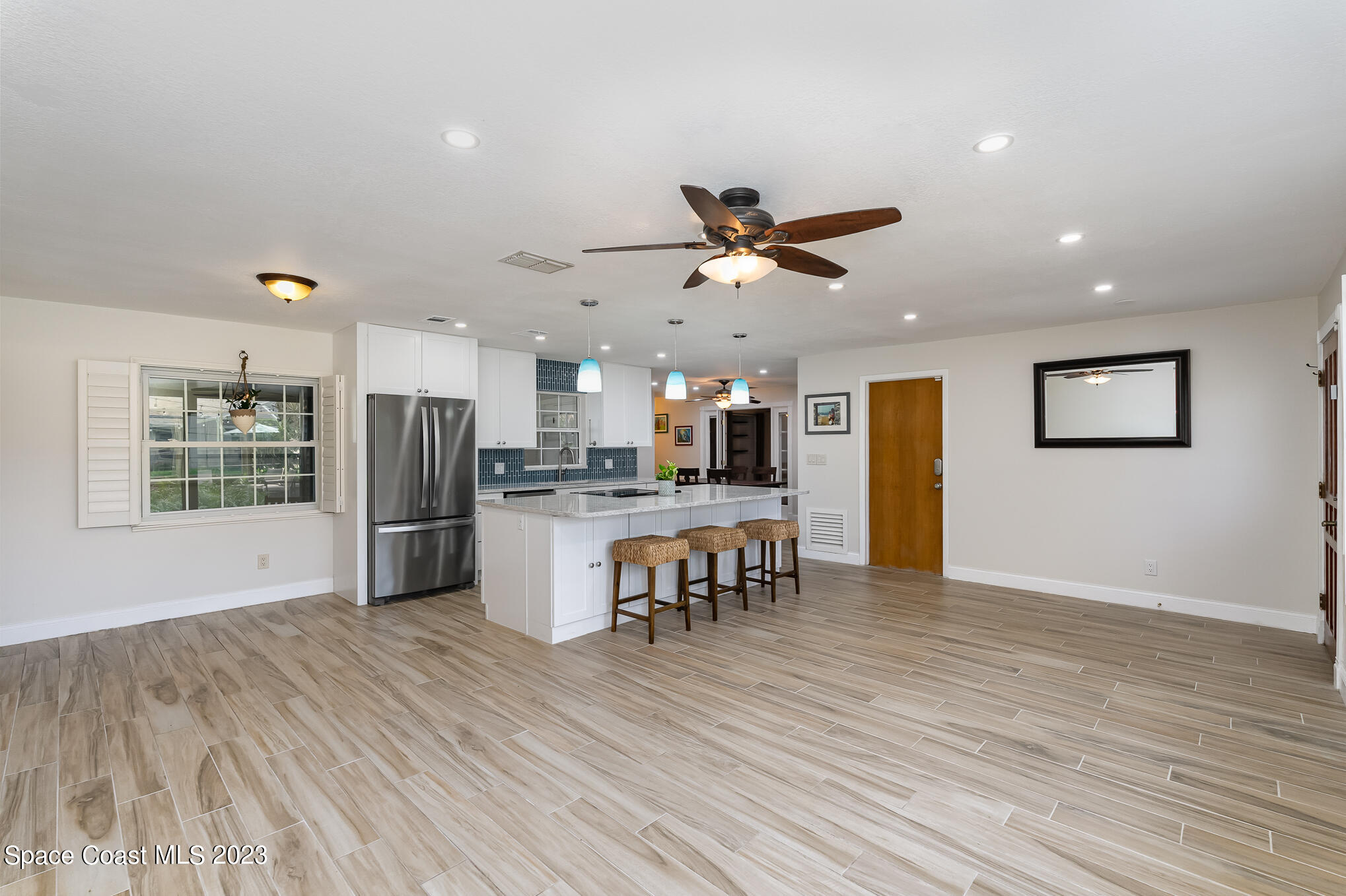 2842 Watkins Drive Melbourne, FL 32901 - Photo 2 of 39 a view of a kitchen with refrigerator and wooden floor