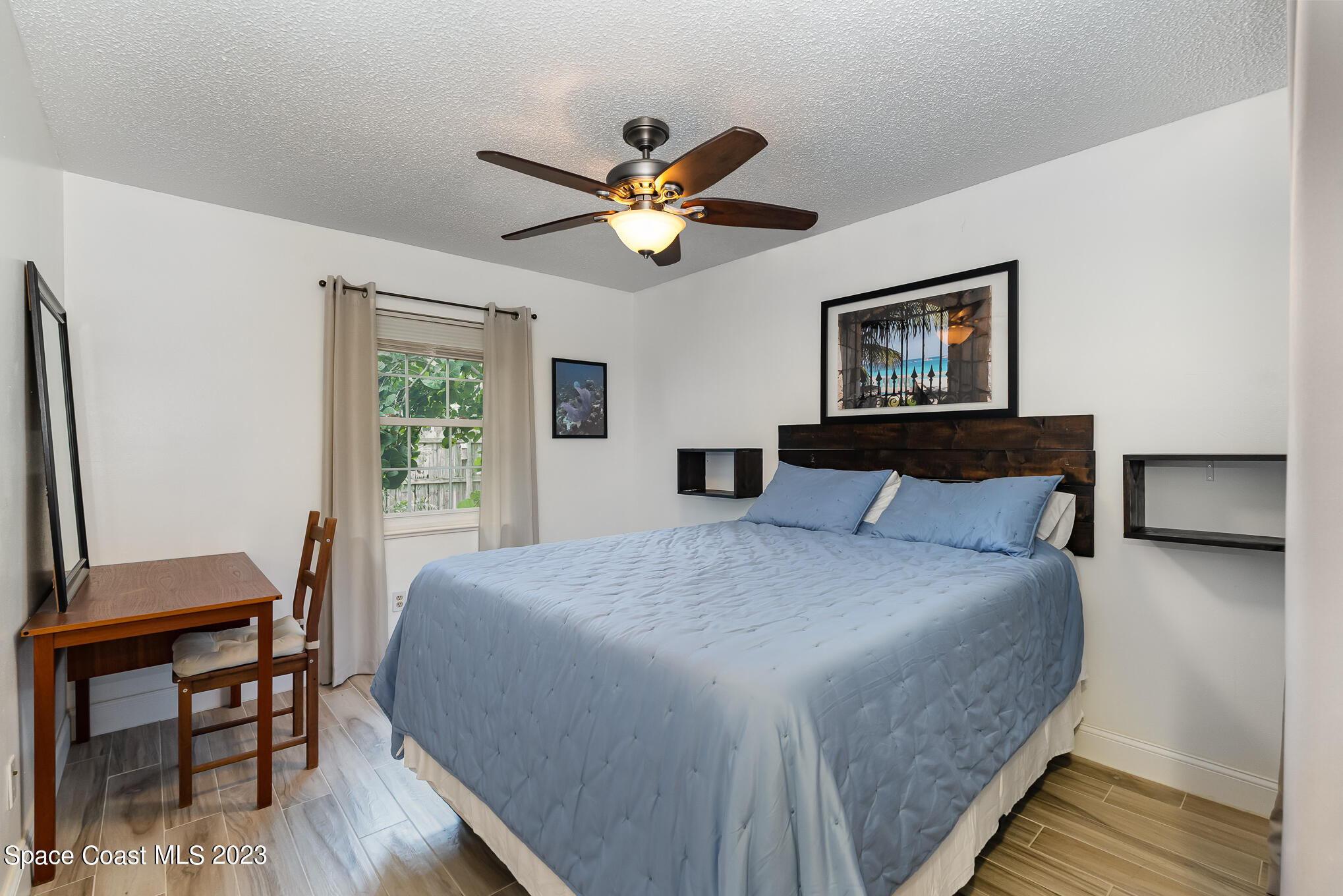 2842 Watkins Drive Melbourne, FL 32901 - Photo 22 of 39 a bedroom with a bed and a chandelier