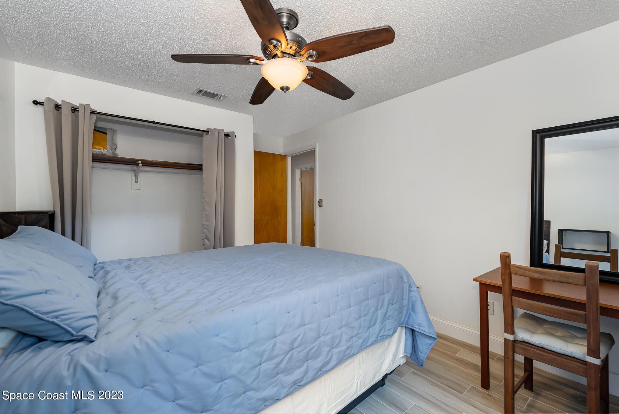 2842 Watkins Drive Melbourne, FL 32901 - Photo 23 of 39 a bedroom with a bed and a dresser