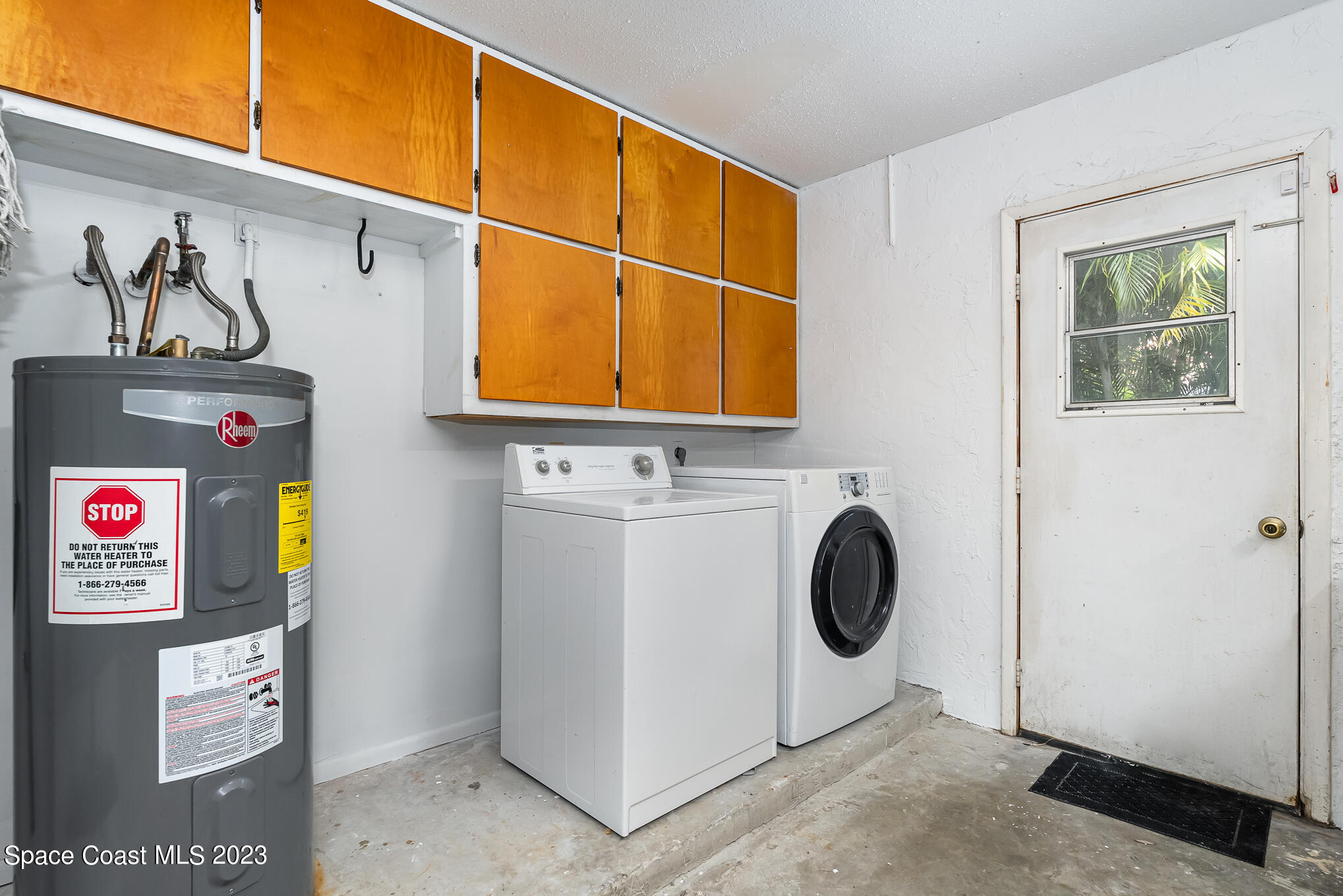 2842 Watkins Drive Melbourne, FL 32901 - Photo 24 of 39 a utility room with dryer and washer