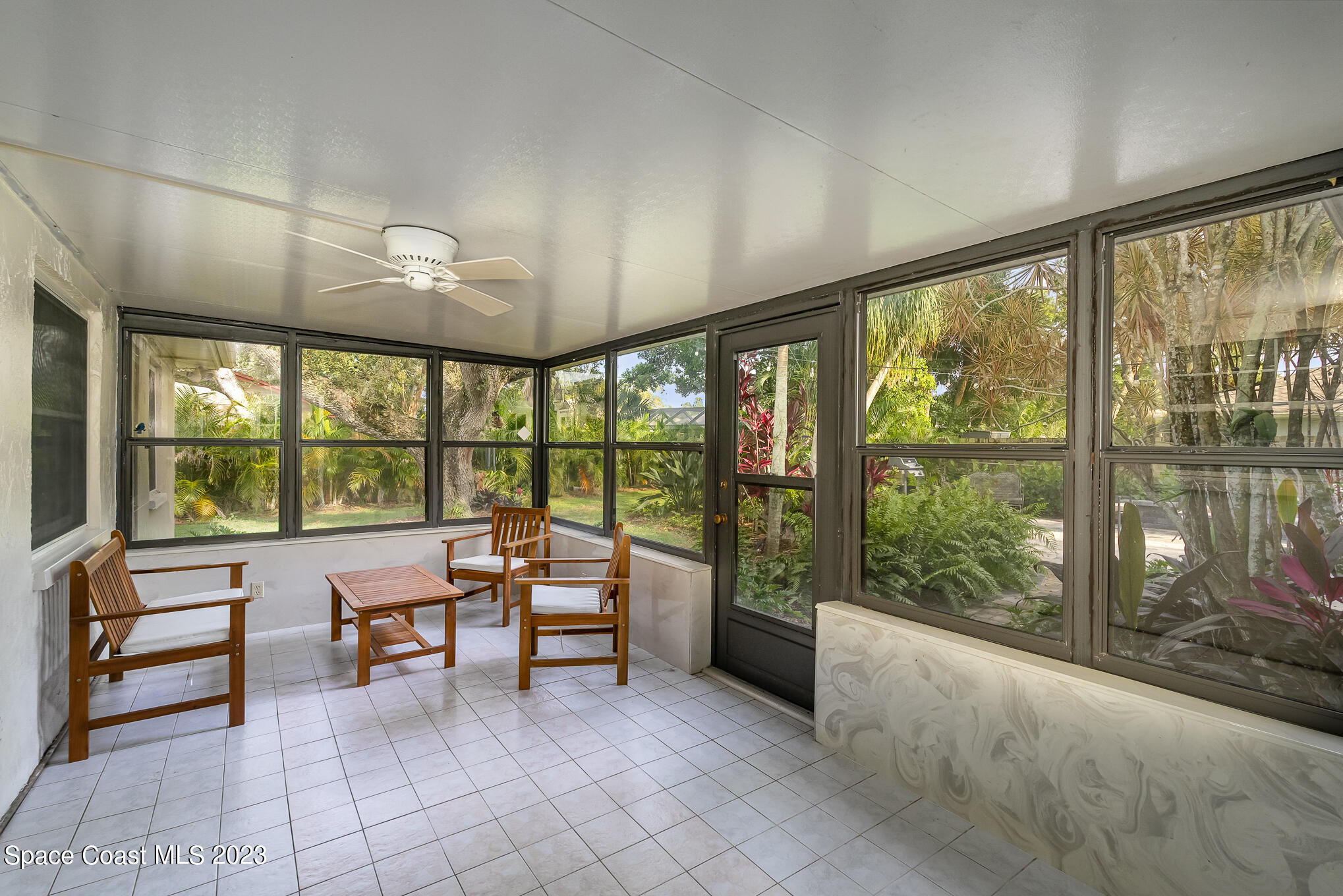 2842 Watkins Drive Melbourne, FL 32901 - Photo 25 of 39 a living room with furniture and a floor to ceiling window