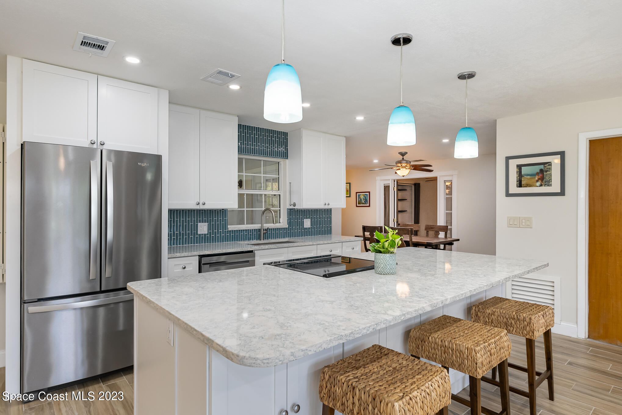 2842 Watkins Drive Melbourne, FL 32901 - Photo 4 of 39 a kitchen with refrigerator and chairs