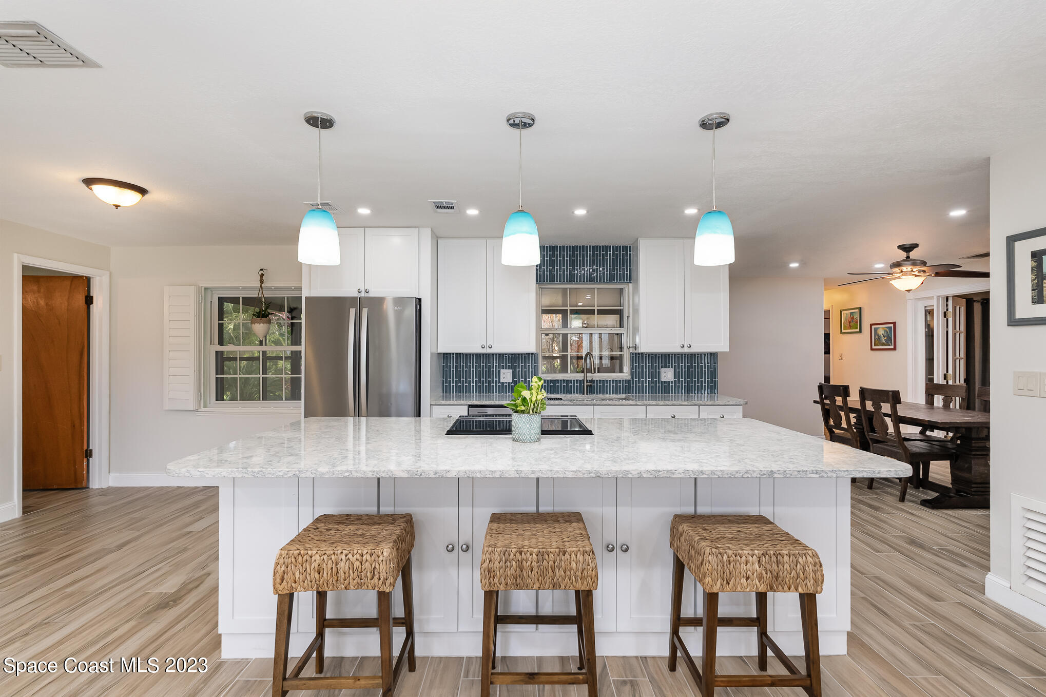 2842 Watkins Drive Melbourne, FL 32901 - Photo 5 of 39 a kitchen with granite countertop a table chairs stove a sink and dishwasher
