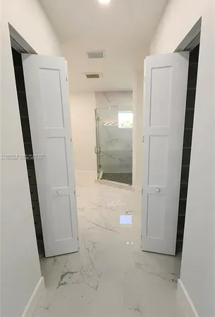 a room with a sink and a mirror