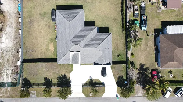 an aerial view of a house with a yard and fountain