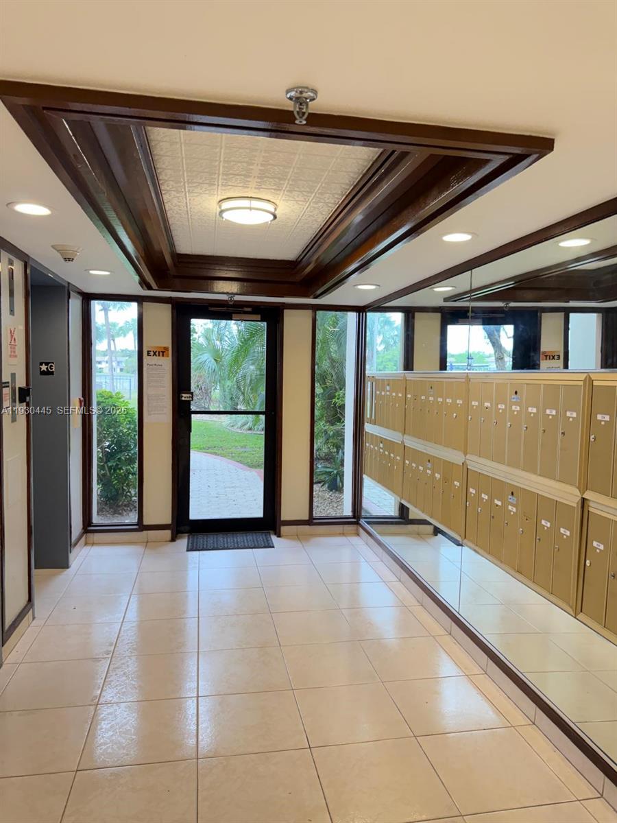 671 Northeast 195th Street, Unit 121E Miami, FL 33179 - Photo 11 of 39 a view of a room with furniture and a large window