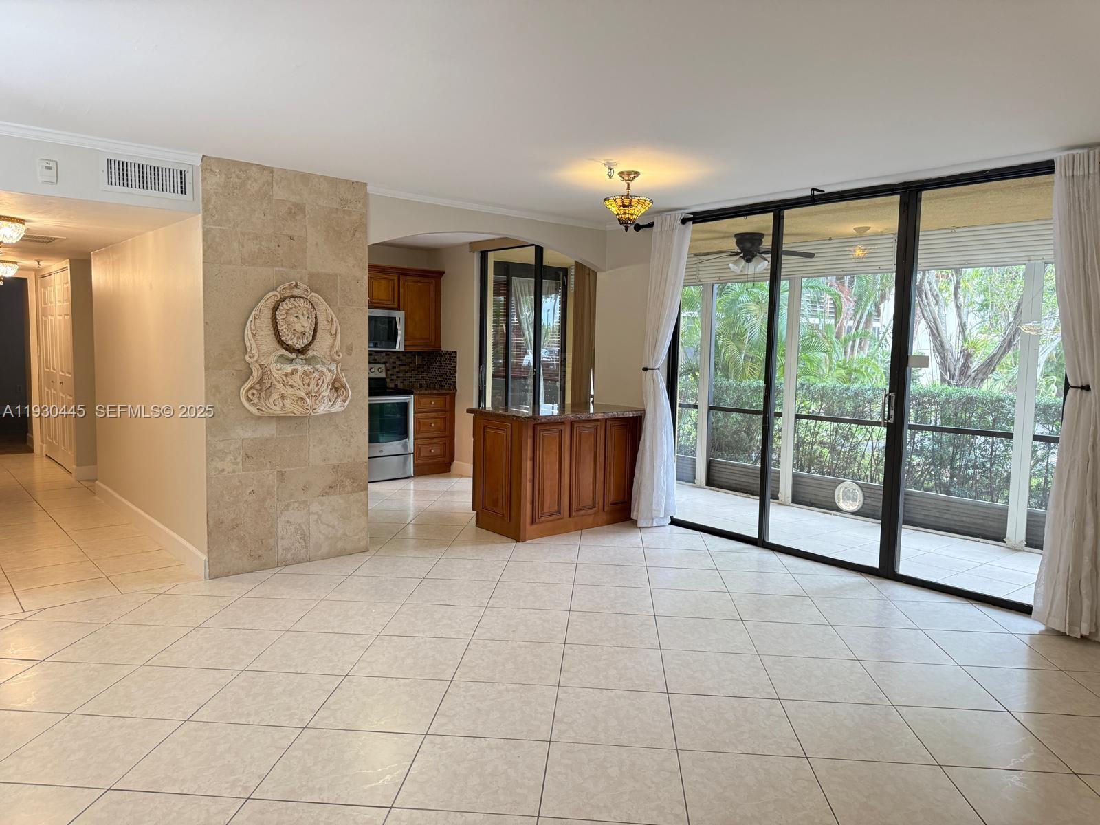 671 Northeast 195th Street, Unit 121E Miami, FL 33179 - Photo 16 of 39 a view of an entryway with floor to ceiling window and an outdoor view