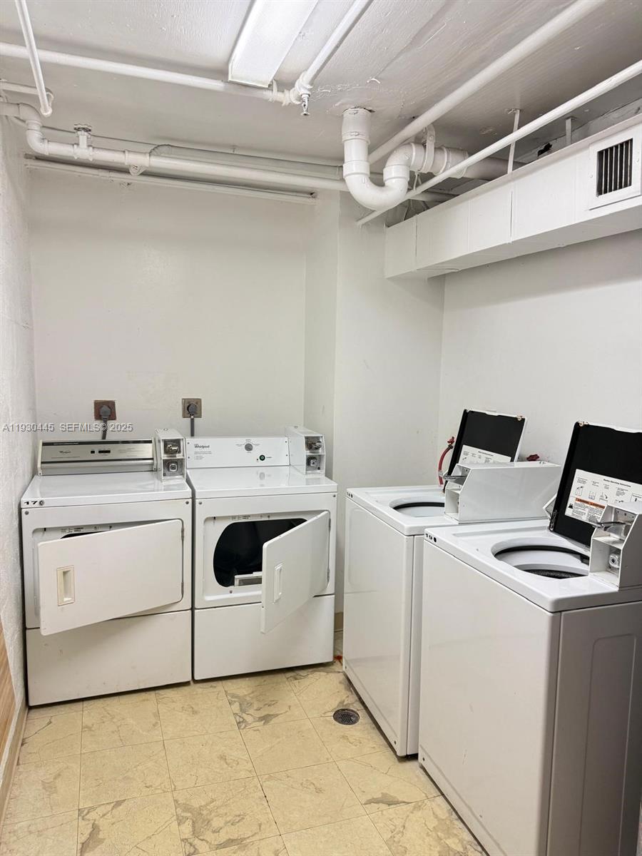 671 Northeast 195th Street, Unit 121E Miami, FL 33179 - Photo 35 of 39 a utility room with dryer and washer