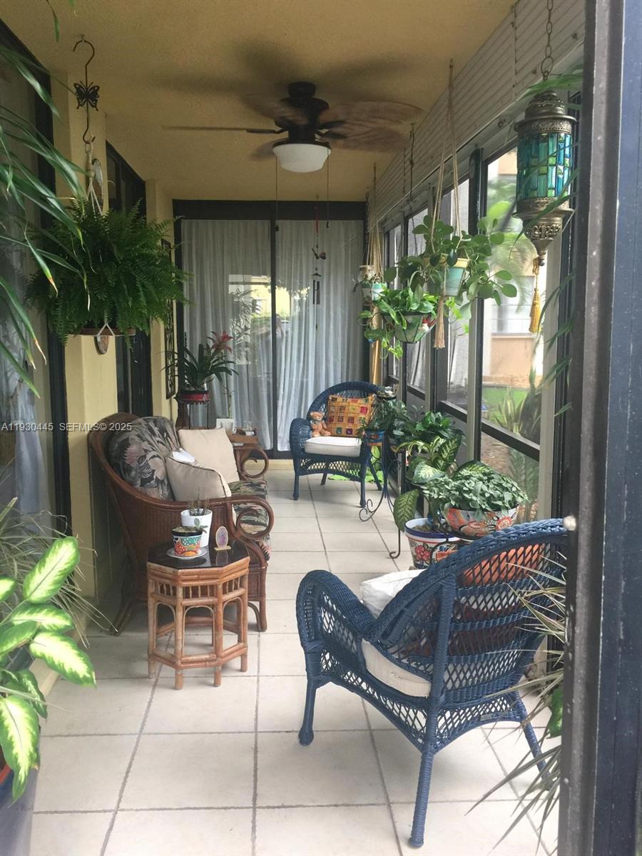 671 Northeast 195th Street, Unit 121E Miami, FL 33179 - Photo 38 of 39 a outdoor living space with furniture and a potted plant