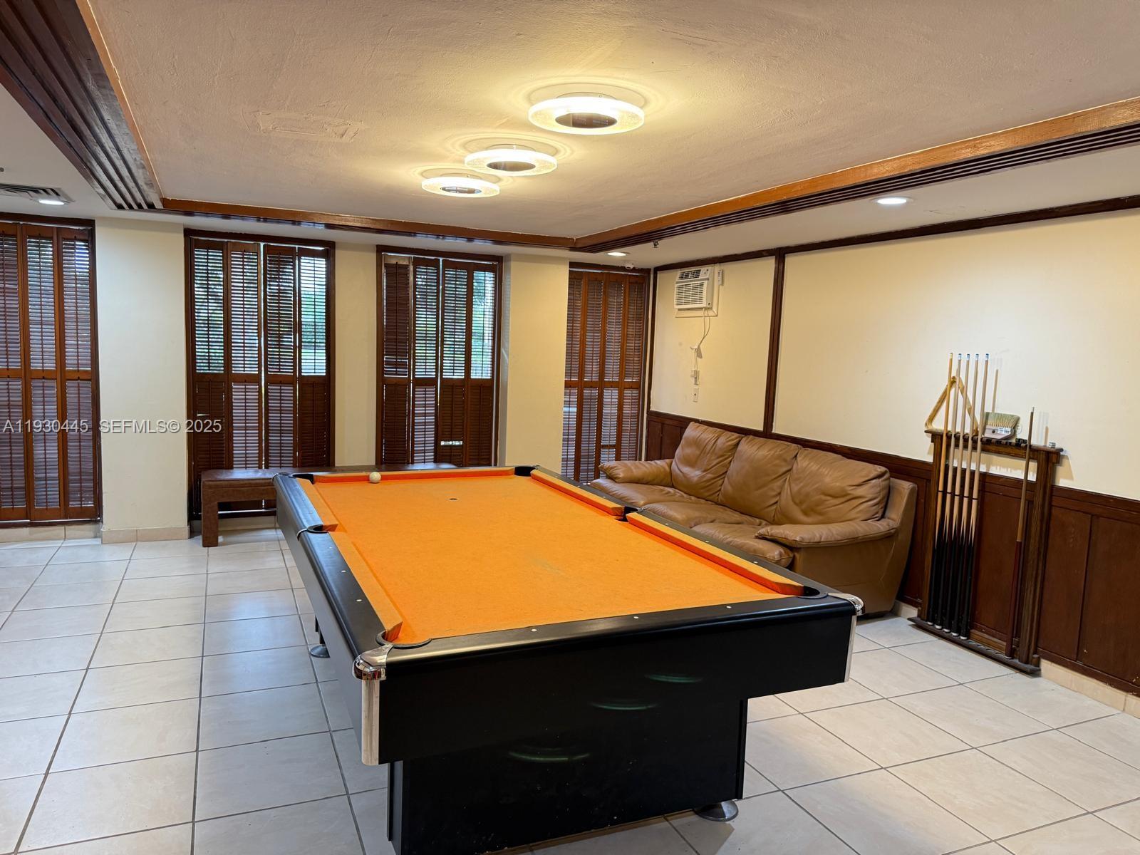 671 Northeast 195th Street, Unit 121E Miami, FL 33179 - Photo 6 of 39 a room with pool table and glass windows