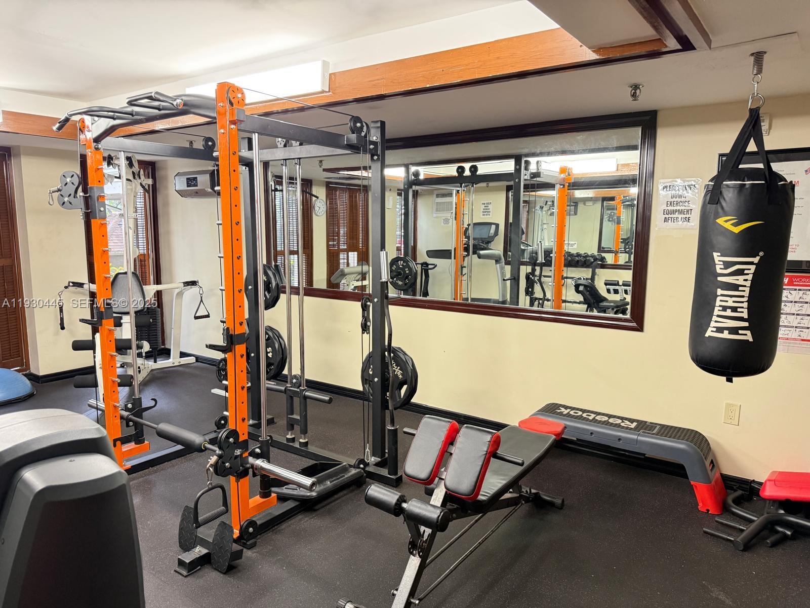 671 Northeast 195th Street, Unit 121E Miami, FL 33179 - Photo 8 of 39 a view of a room with gym equipment