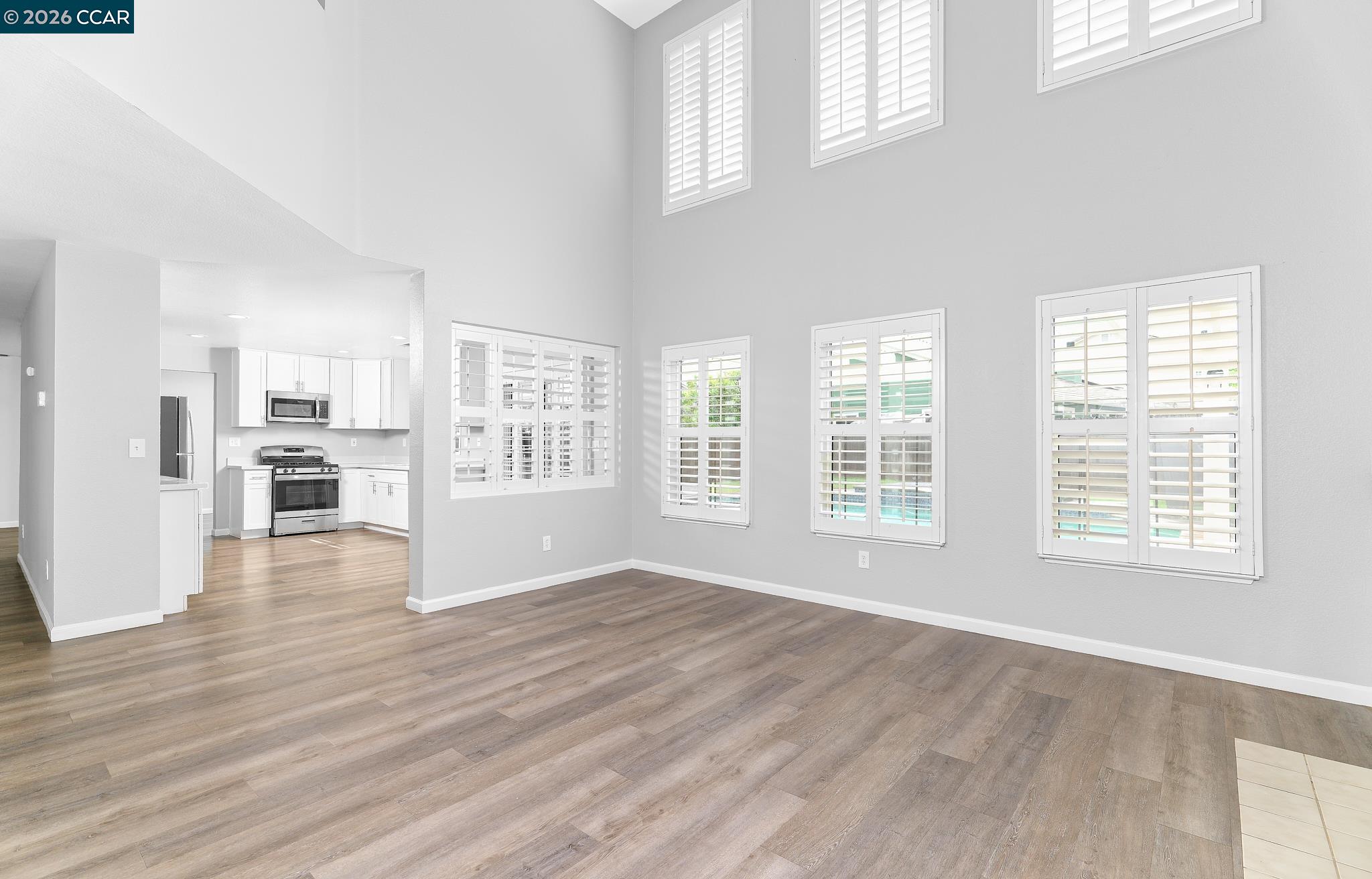 1128 Prewett Ranch Drive Antioch, CA 94531 - Photo 15 of 31 a view of an empty room with wooden floor and a window