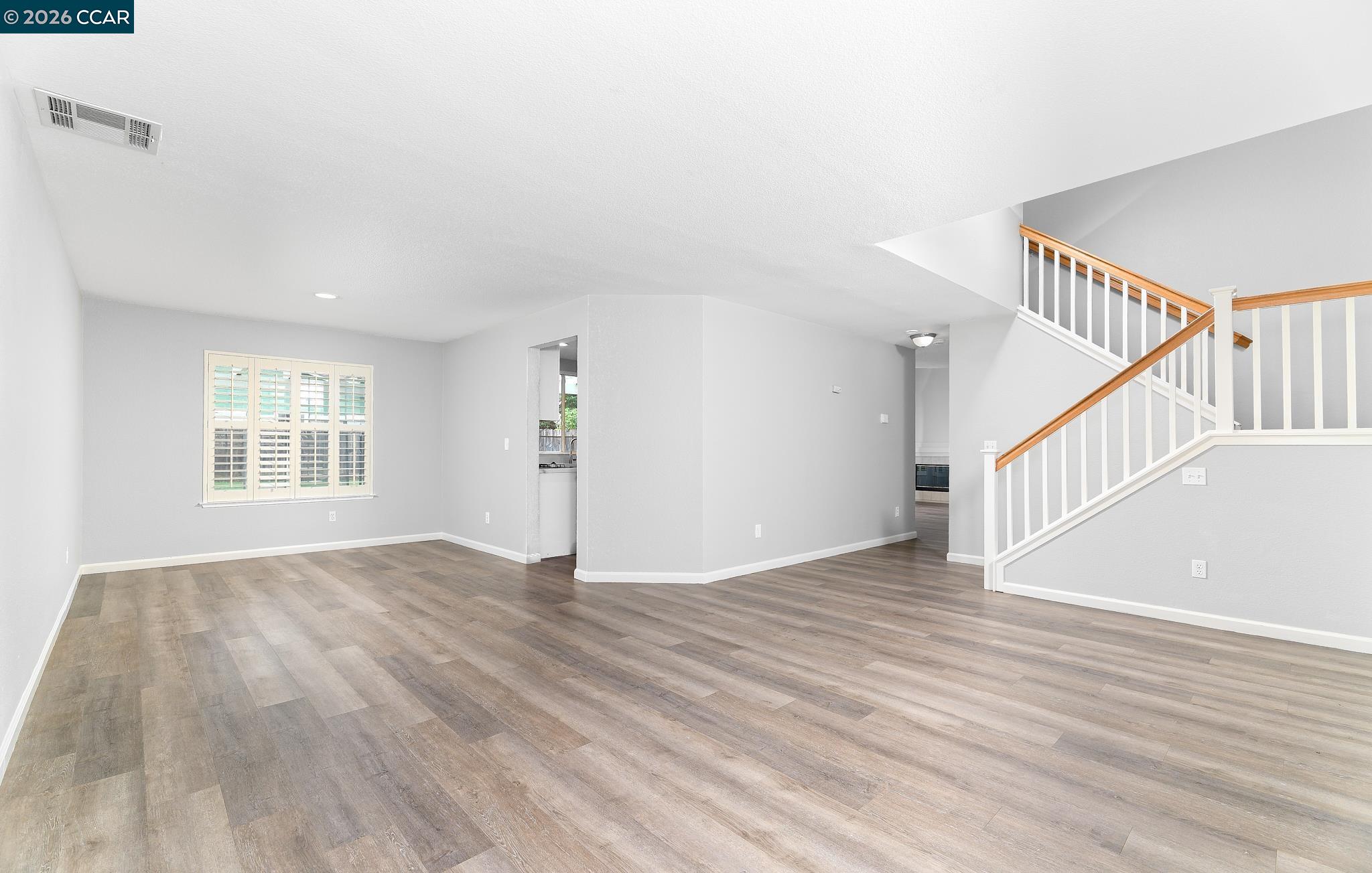 1128 Prewett Ranch Drive Antioch, CA 94531 - Photo 17 of 31 a view of an empty room with wooden floor and a window