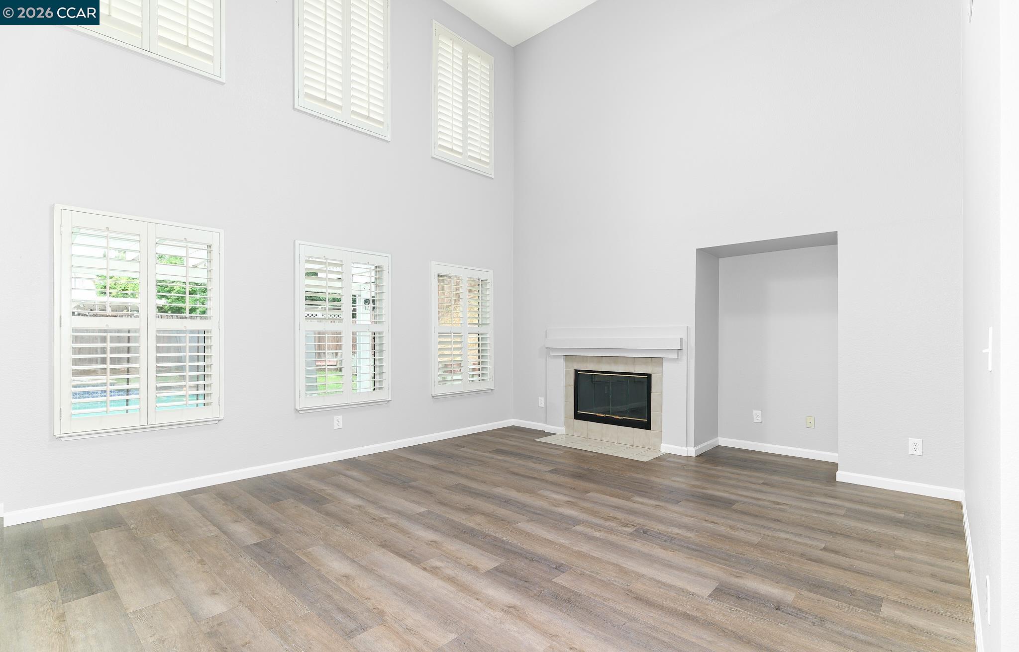1128 Prewett Ranch Drive Antioch, CA 94531 - Photo 18 of 31 a view of an empty room with wooden floor fireplace and a window