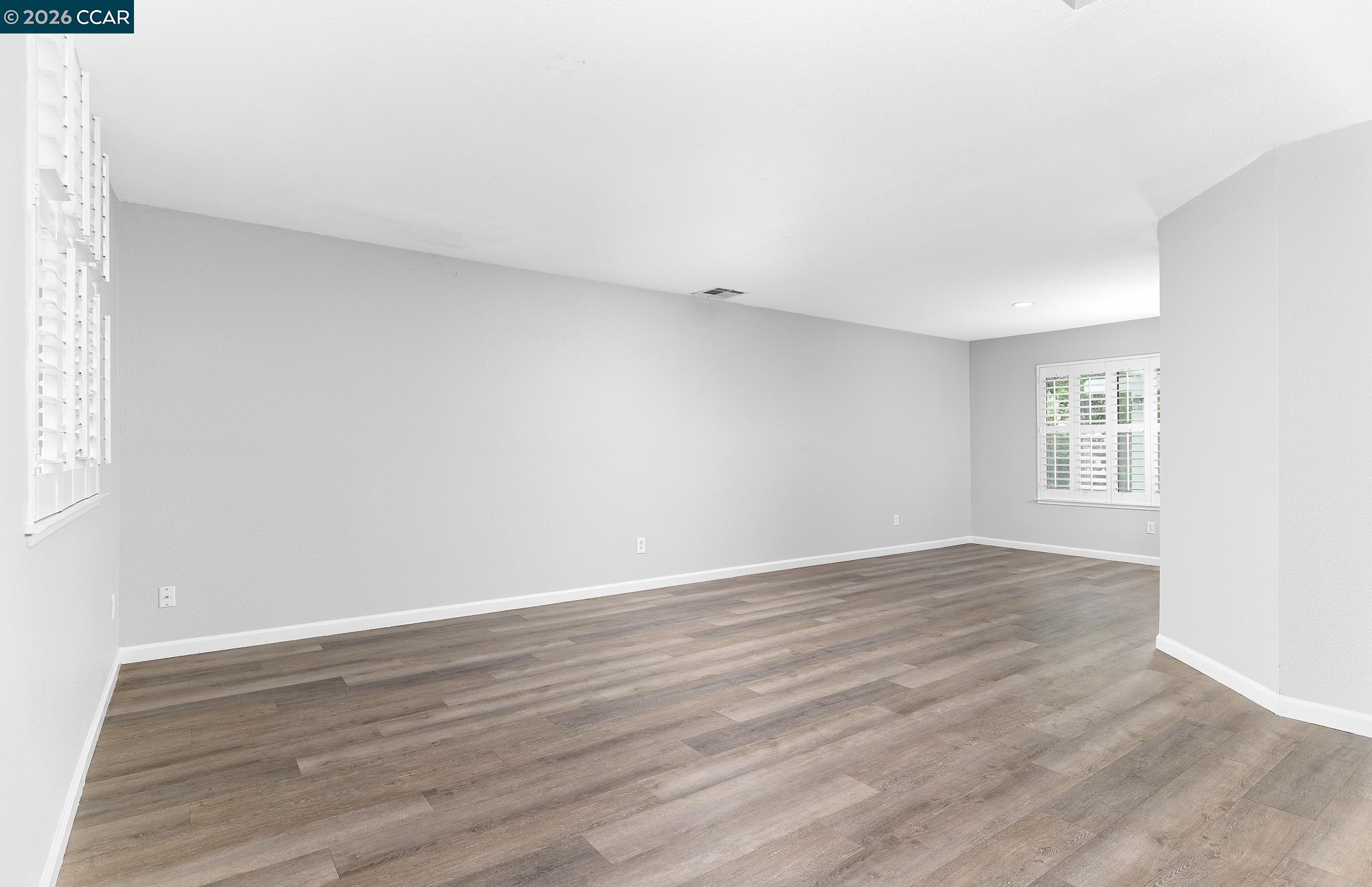1128 Prewett Ranch Drive Antioch, CA 94531 - Photo 19 of 31 a view of an empty room with wooden floor and a window