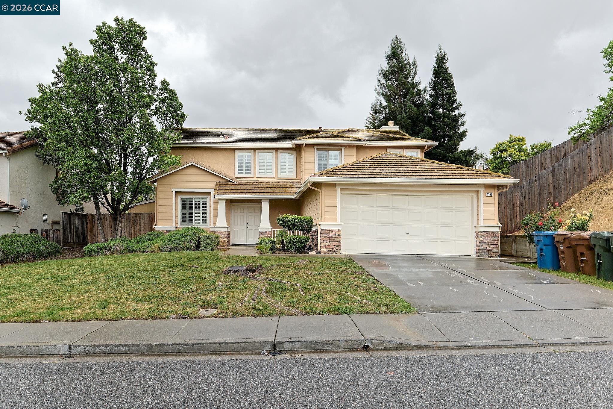 1128 Prewett Ranch Drive Antioch, CA 94531 - Photo 2 of 31 a front view of a house with a yard and garage