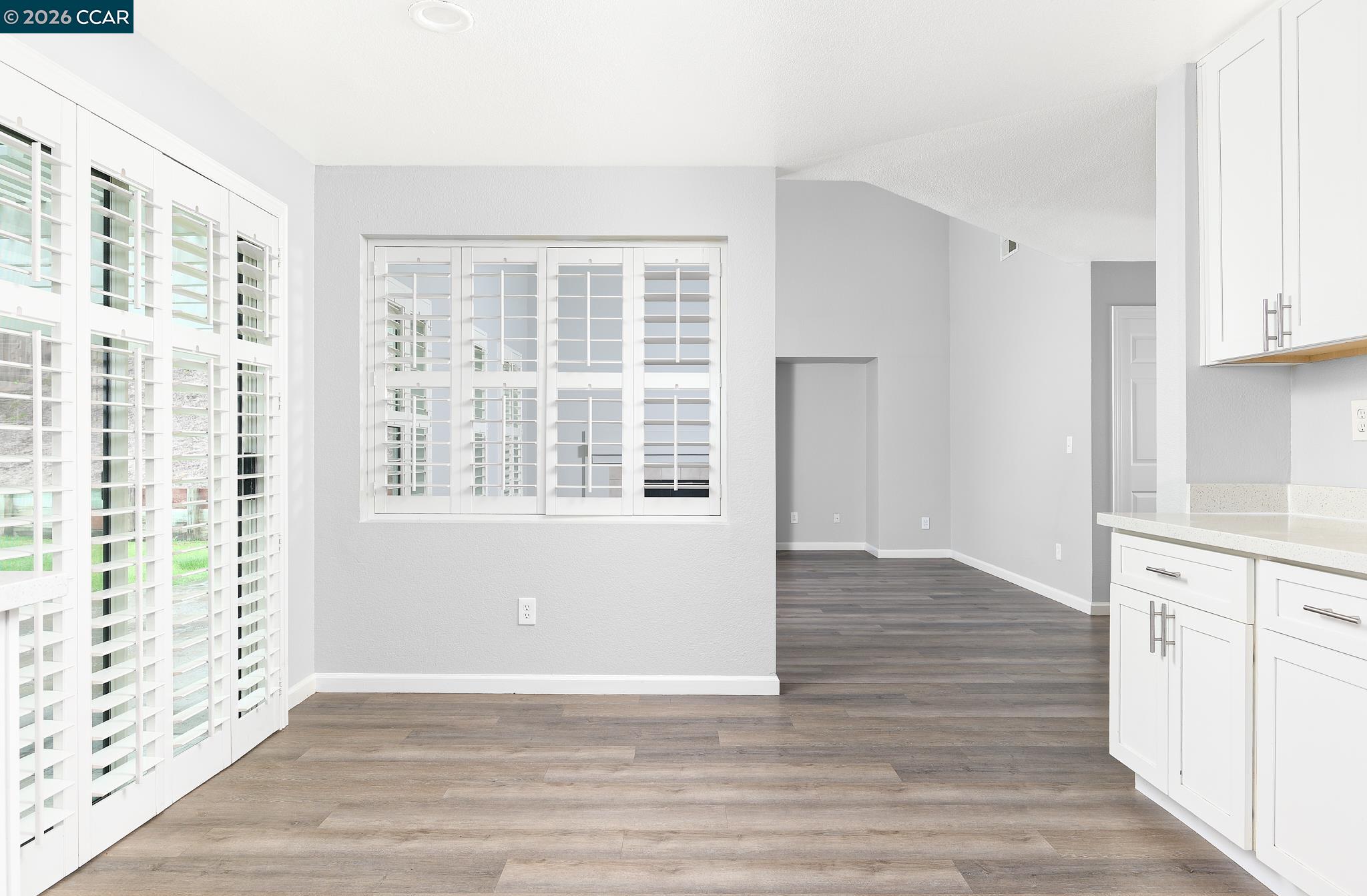 1128 Prewett Ranch Drive Antioch, CA 94531 - Photo 21 of 31 a view of an empty room with wooden floor and a window