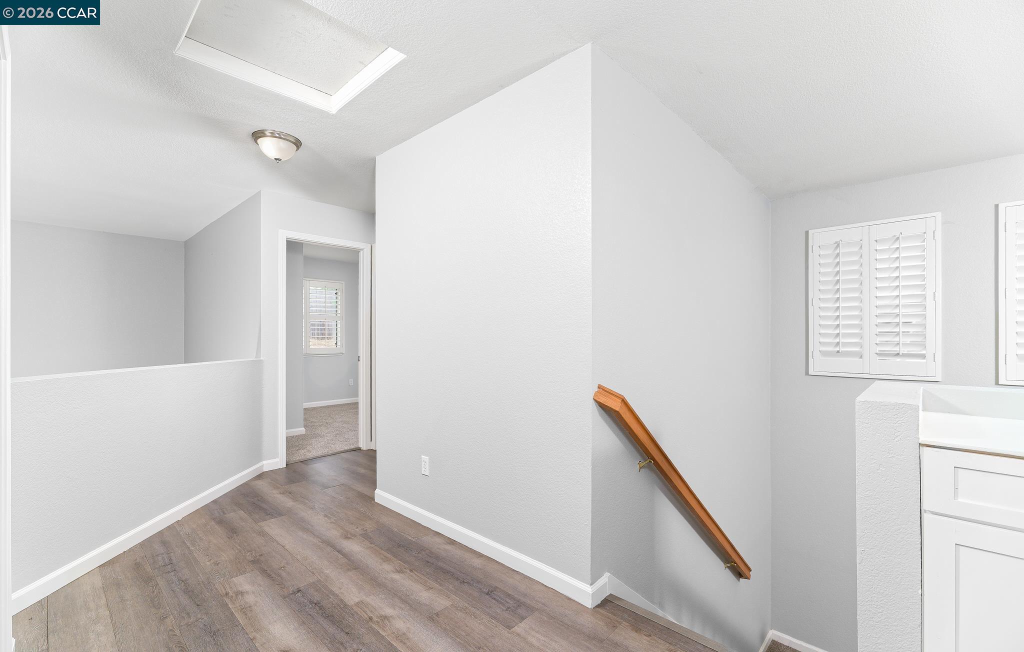 1128 Prewett Ranch Drive Antioch, CA 94531 - Photo 22 of 31 a view of hallway with stairs and wooden floor