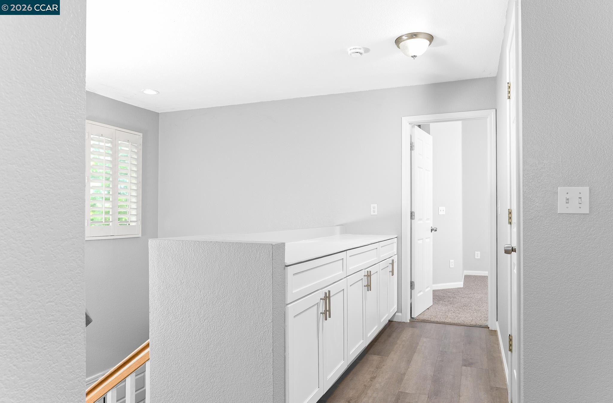1128 Prewett Ranch Drive Antioch, CA 94531 - Photo 29 of 31 a view of a hallway with wooden floor and cabinet