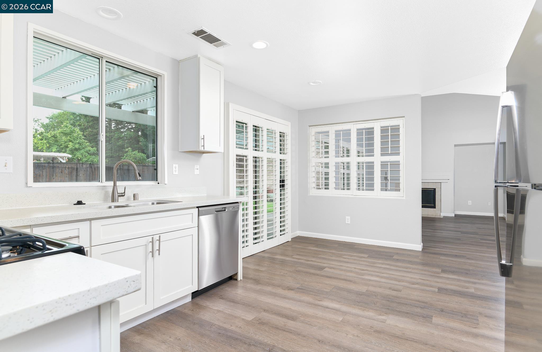 1128 Prewett Ranch Drive Antioch, CA 94531 - Photo 6 of 31 a large white kitchen with granite countertop a large window and a sink