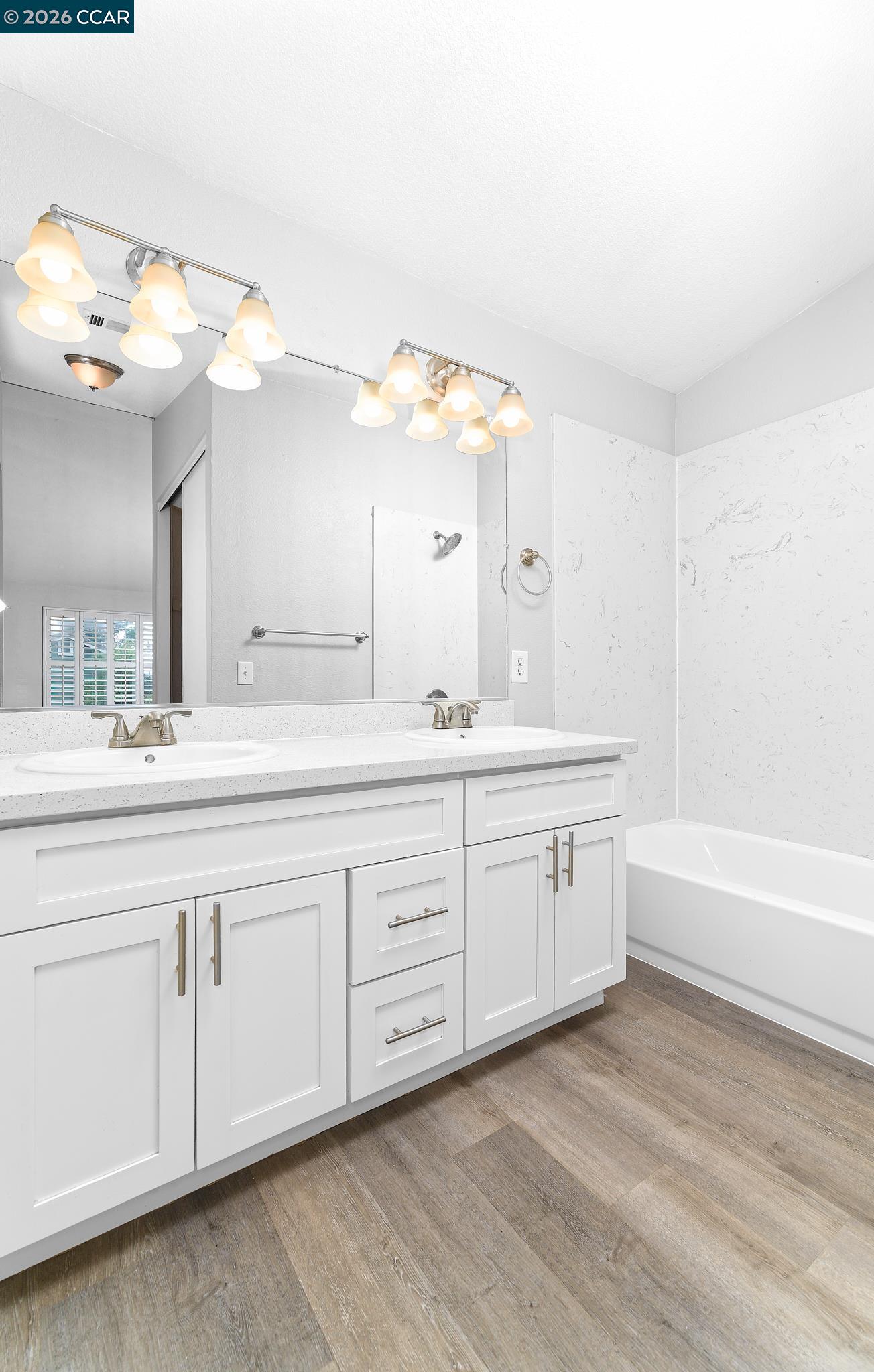 1128 Prewett Ranch Drive Antioch, CA 94531 - Photo 7 of 31 a spacious bathroom with a granite countertop sink a mirror and a bathtub