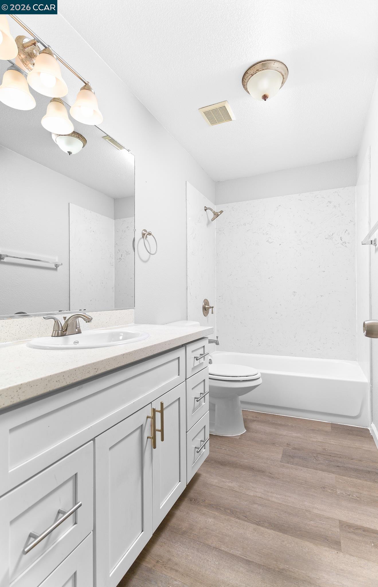 1128 Prewett Ranch Drive Antioch, CA 94531 - Photo 8 of 31 a bathroom with a granite countertop toilet a sink and a bathtub