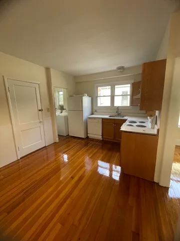 a room with wooden floors and white walls