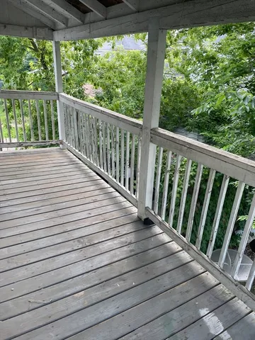 a view of a balcony with wooden floor