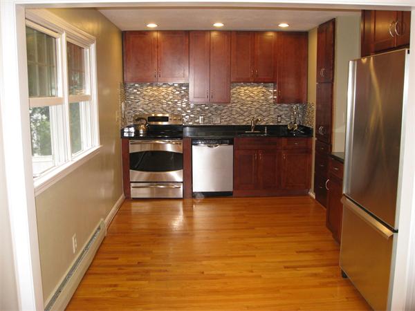 1 Ellen Road Marblehead, MA 01945 - Photo 7 of 30 a kitchen with kitchen island granite countertop a refrigerator and a sink