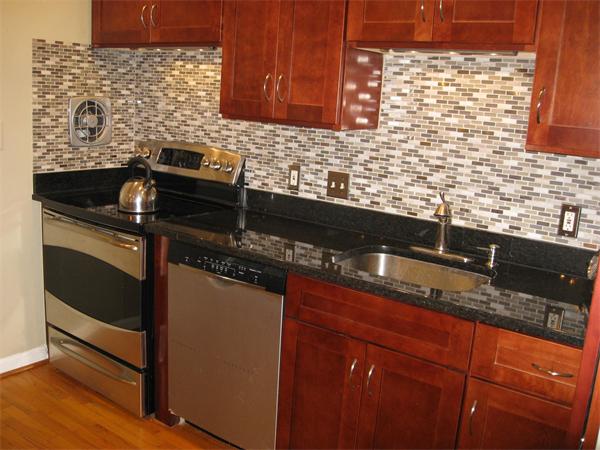 1 Ellen Road Marblehead, MA 01945 - Photo 9 of 30 a kitchen with granite countertop cabinets and black stainless steel appliances