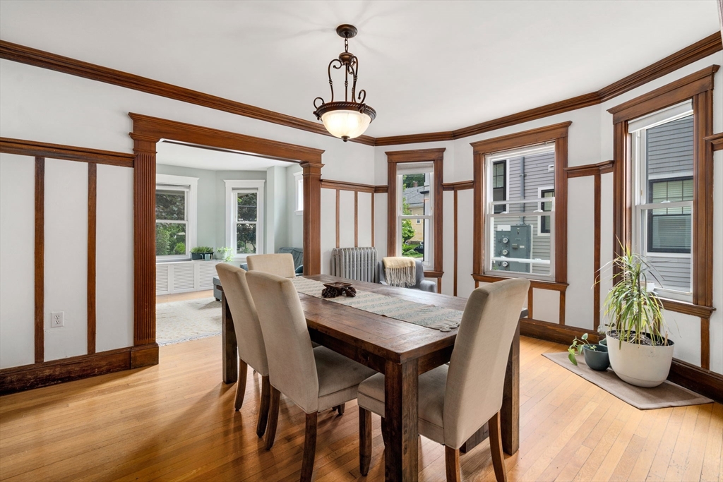 18 Park Road, Unit 1 Belmont, MA 02478 - Photo 13 of 36 a dining room with furniture wooden floor a potted plant and a chandelier