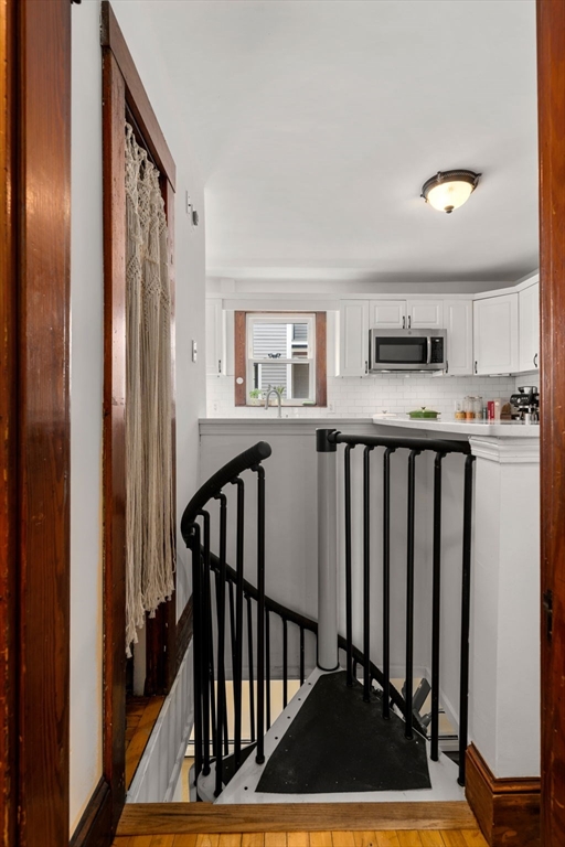 18 Park Road, Unit 1 Belmont, MA 02478 - Photo 15 of 36 a view of a hallway with wooden floor and staircase
