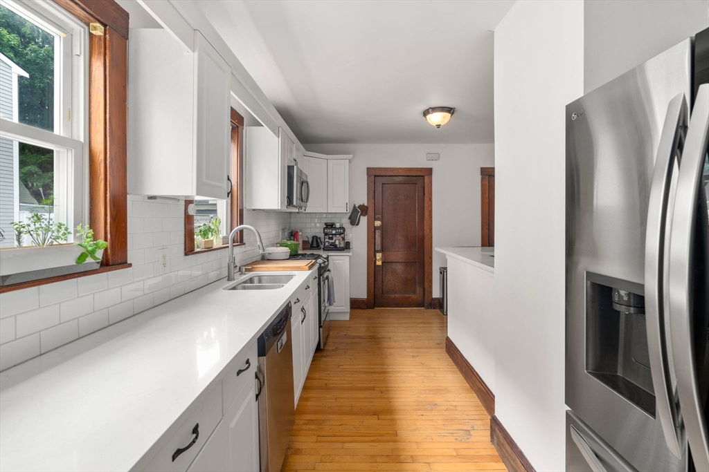 18 Park Road, Unit 1 Belmont, MA 02478 - Photo 16 of 36 a kitchen with stainless steel appliances a refrigerator sink and cabinets