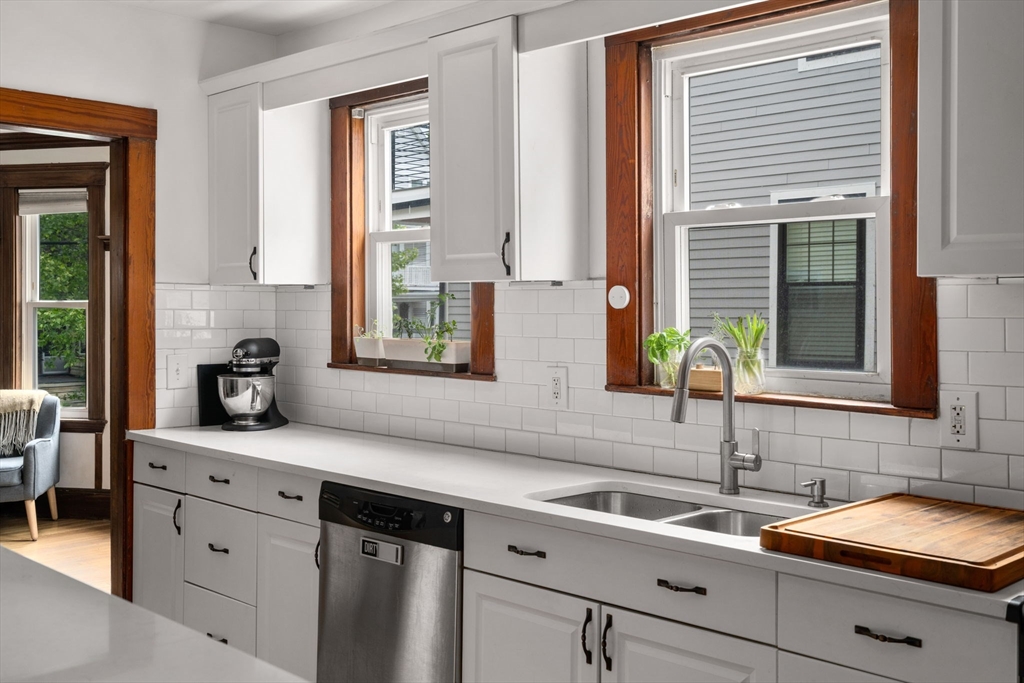 18 Park Road, Unit 1 Belmont, MA 02478 - Photo 20 of 36 a kitchen with stainless steel appliances white cabinets and a window