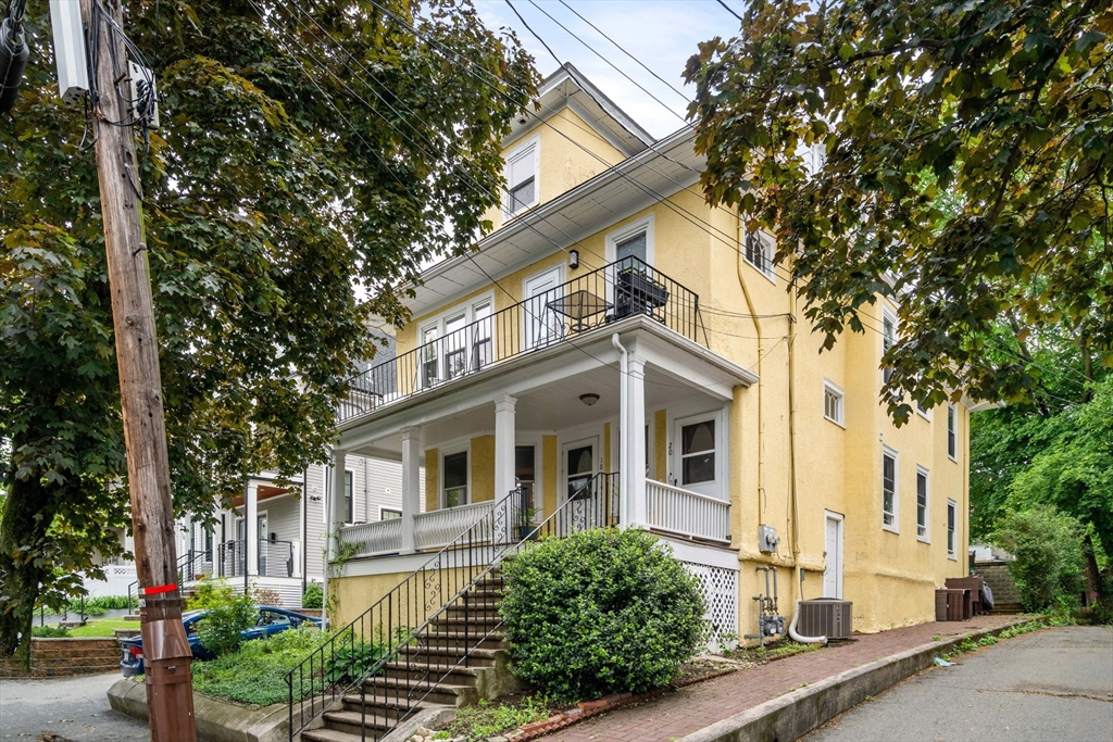 18 Park Road, Unit 1 Belmont, MA 02478 - Photo 2 of 36 a front view of a house with a yard